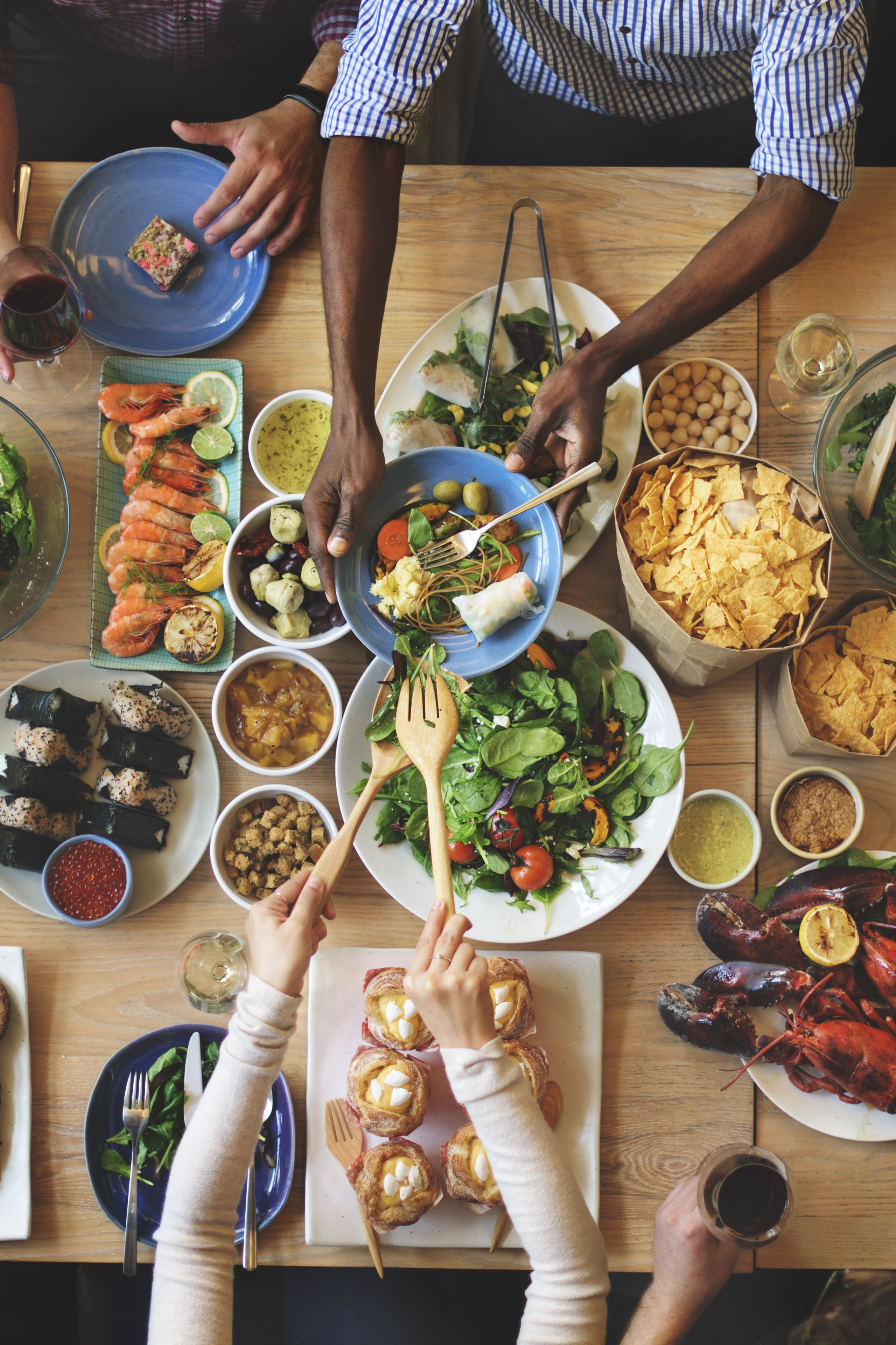 Table spread with Mediterranean dishes and shared dining