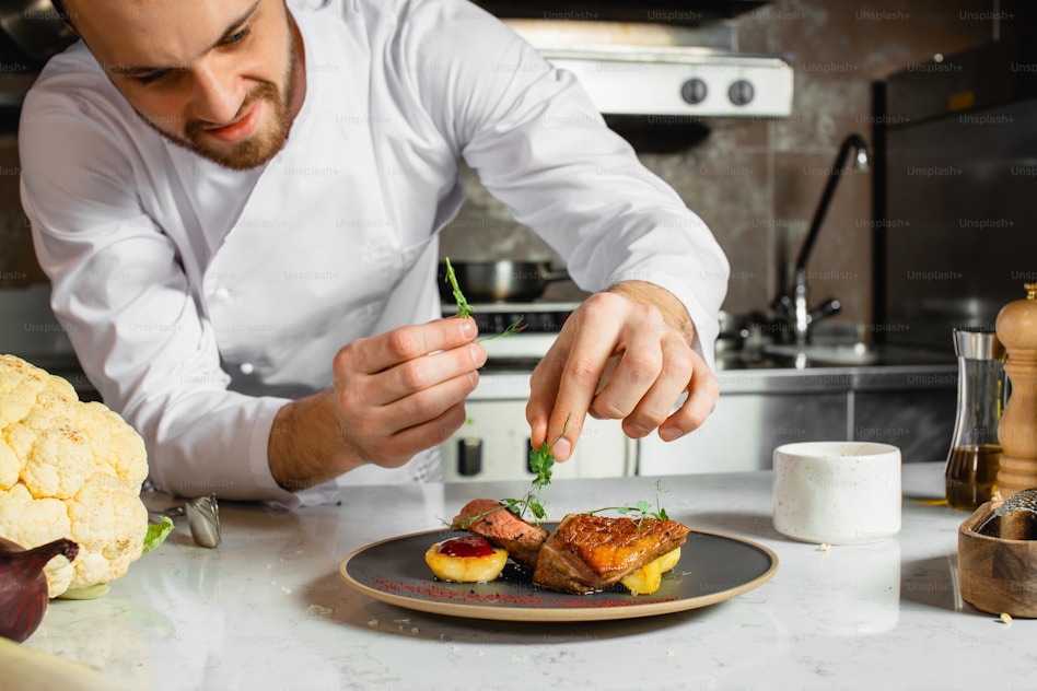 Chef plating food in a professional kitchen