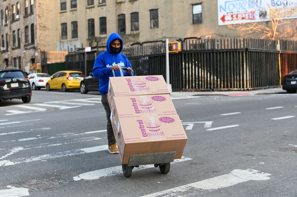 Delivery person moving supply boxes